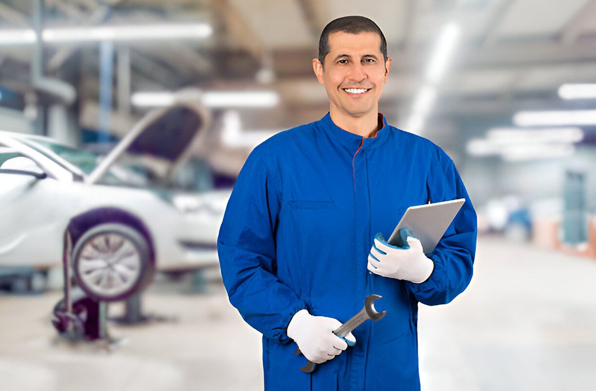 Portrait of smiling male repairman holding wrench and clipboard at repair shop.