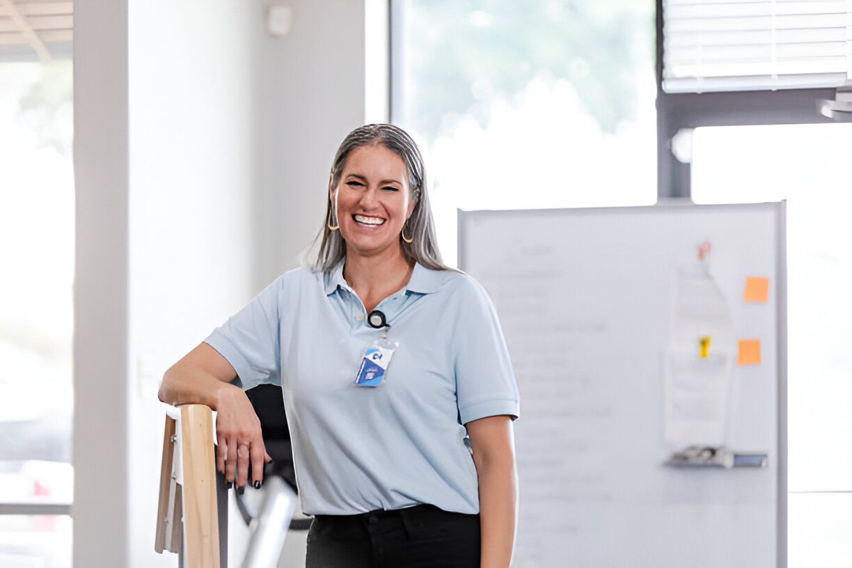 Physical therapist smiles for the camera while she waits for her next patient at the clinic.